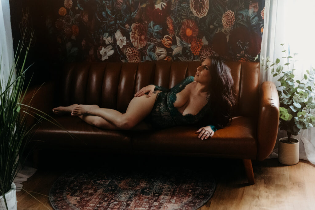 woman on couch boudoir pose for a boudoir photoshoot